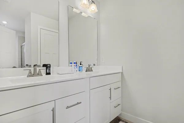 a bathroom with a sink vanity and a mirror