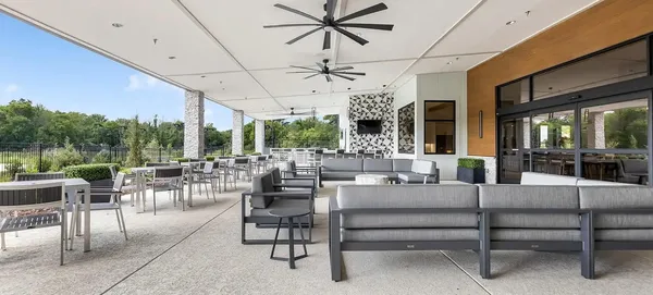 a outdoor space with lots of tables a garden and chairs