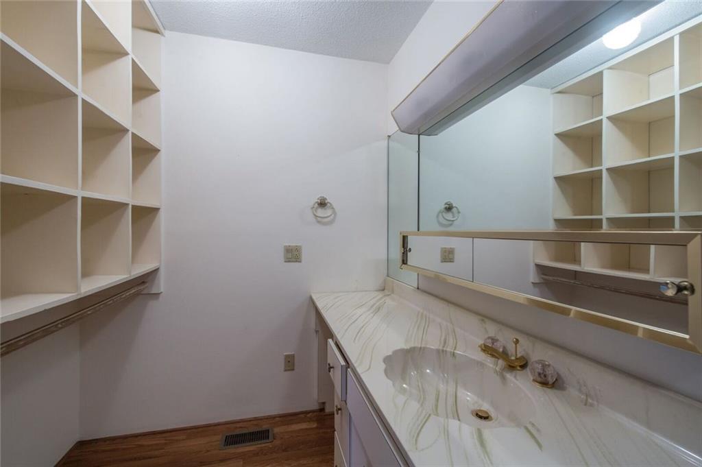 288 Rockledge Road Spruce Pine, NC 28777 - Photo 9 of 27 a bathroom with a granite countertop sink and a bathtub