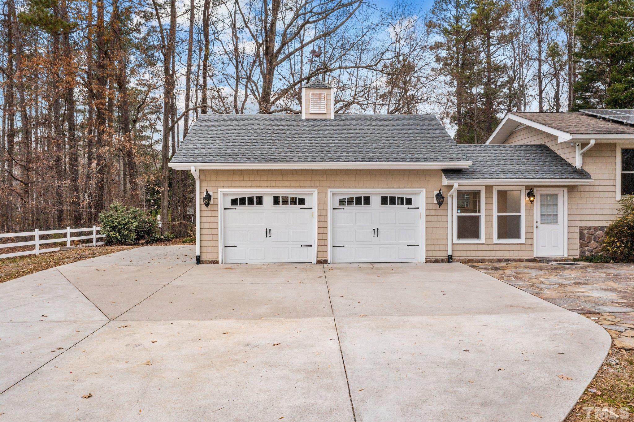 1613 Jenks Carpenter Road Cary, NC 27519 - Photo 2 of 60 a view of a white house with a large tree in front of it