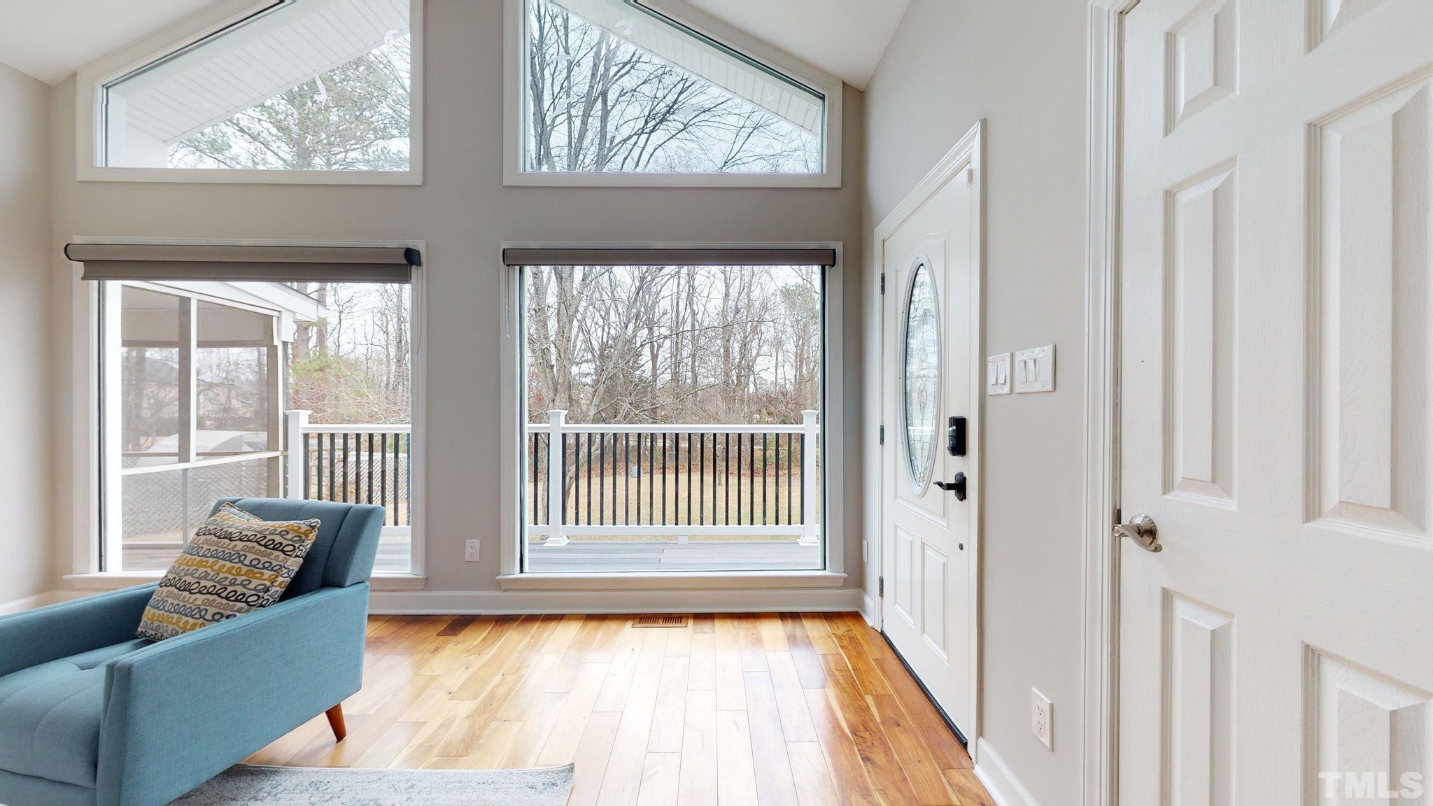 1613 Jenks Carpenter Road Cary, NC 27519 - Photo 21 of 60 a living room with furniture and a floor to ceiling window