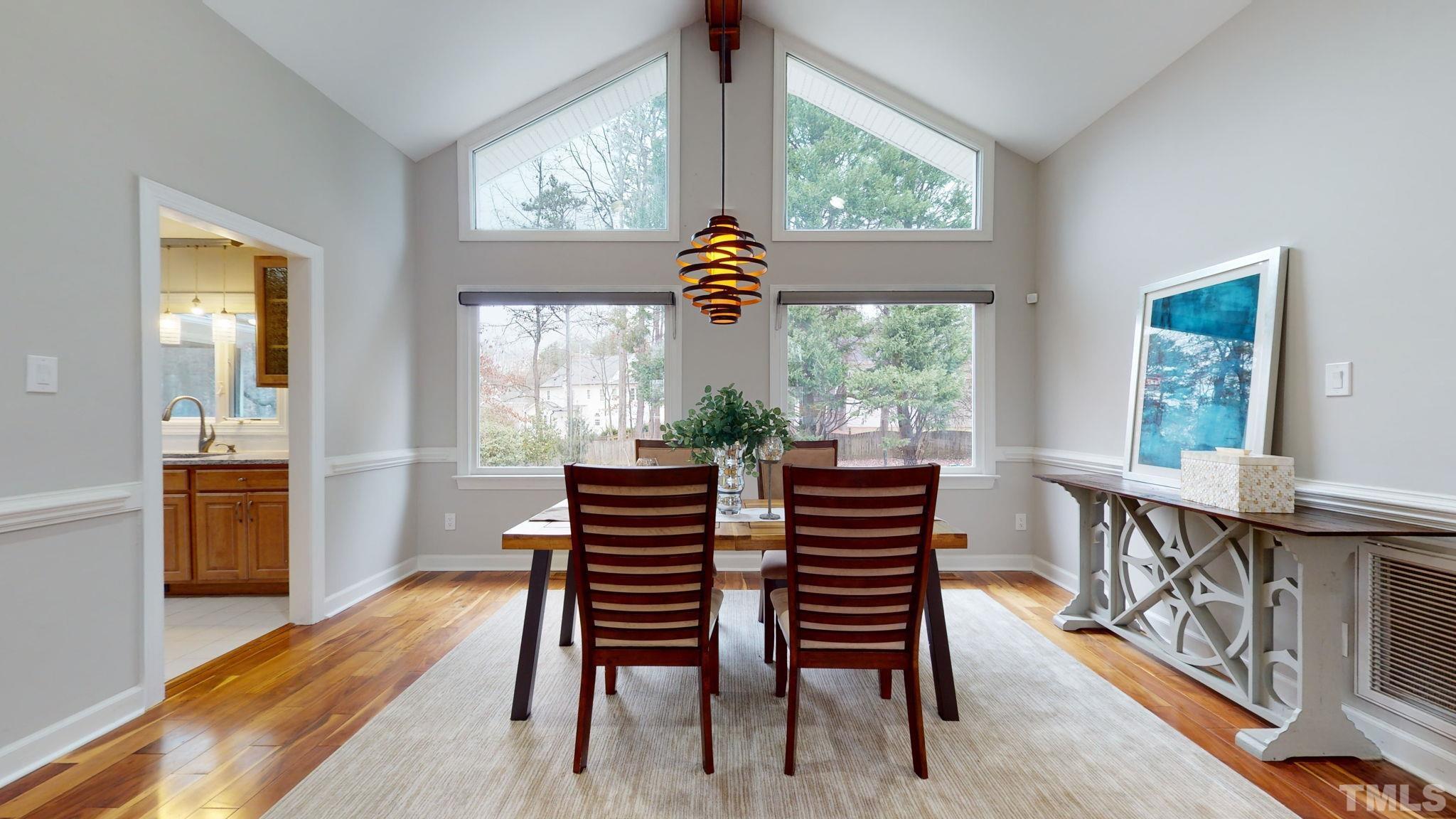 1613 Jenks Carpenter Road Cary, NC 27519 - Photo 27 of 60 a dining room with furniture a chandelier and wooden floor