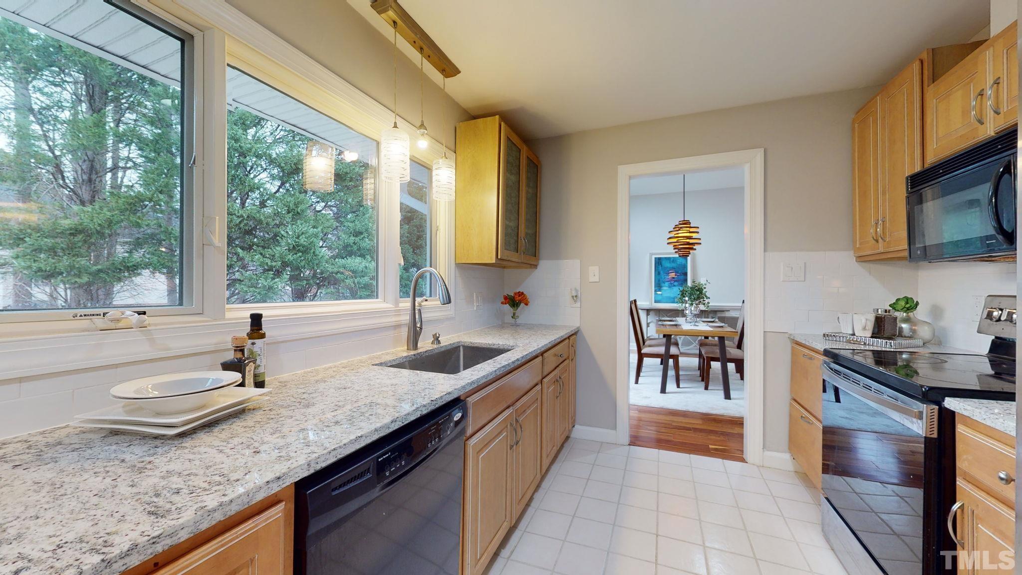 1613 Jenks Carpenter Road Cary, NC 27519 - Photo 32 of 60 a kitchen with granite countertop a sink and a stove