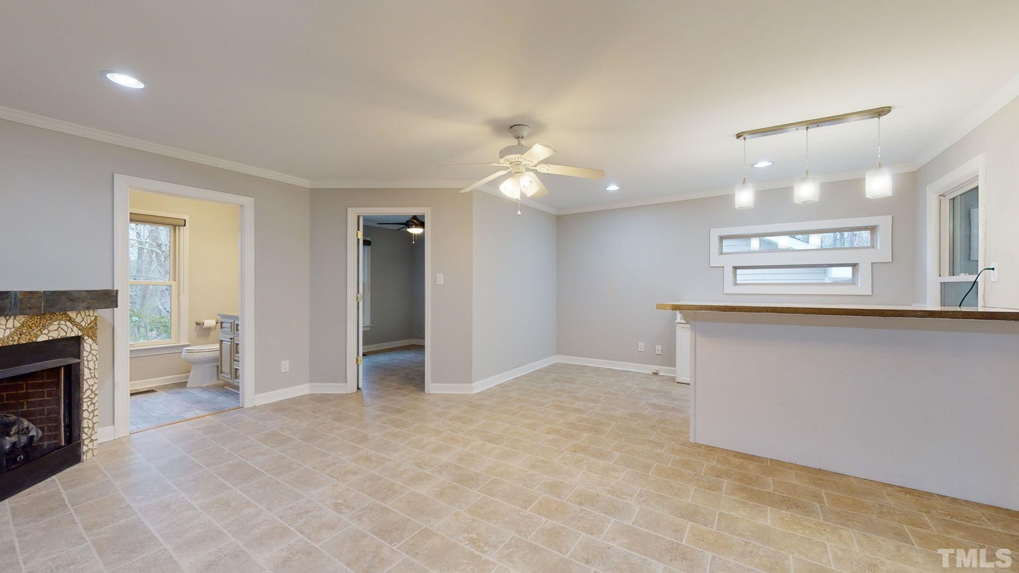 1613 Jenks Carpenter Road Cary, NC 27519 - Photo 34 of 60 a view of an empty room with a fireplace and a window