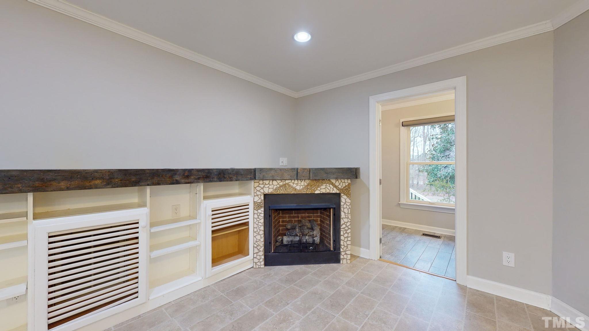1613 Jenks Carpenter Road Cary, NC 27519 - Photo 36 of 60 an empty room with kitchen and fireplace