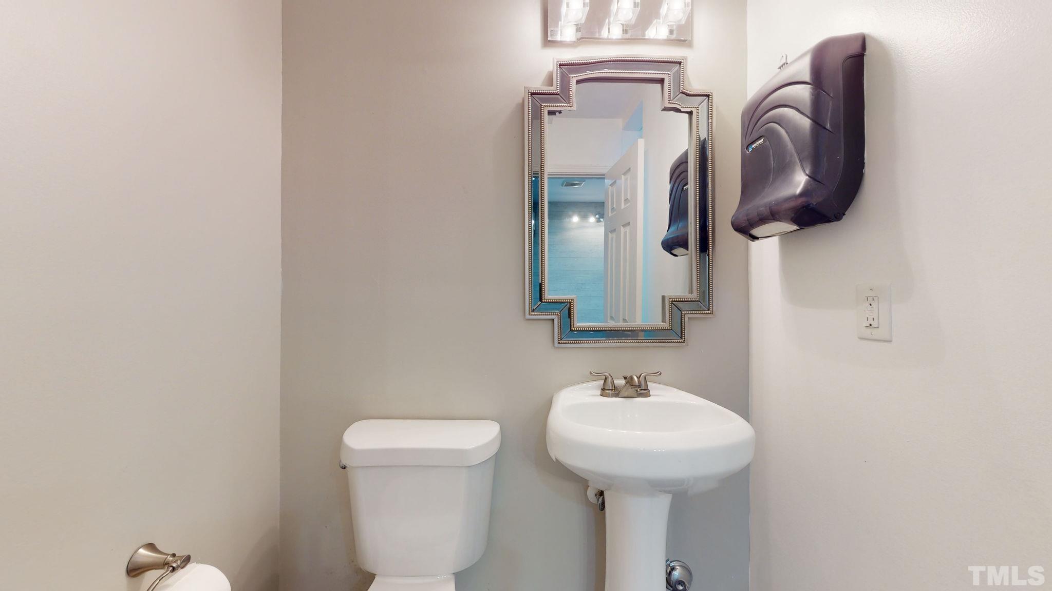 1613 Jenks Carpenter Road Cary, NC 27519 - Photo 43 of 60 a bathroom with a toilet sink and mirror