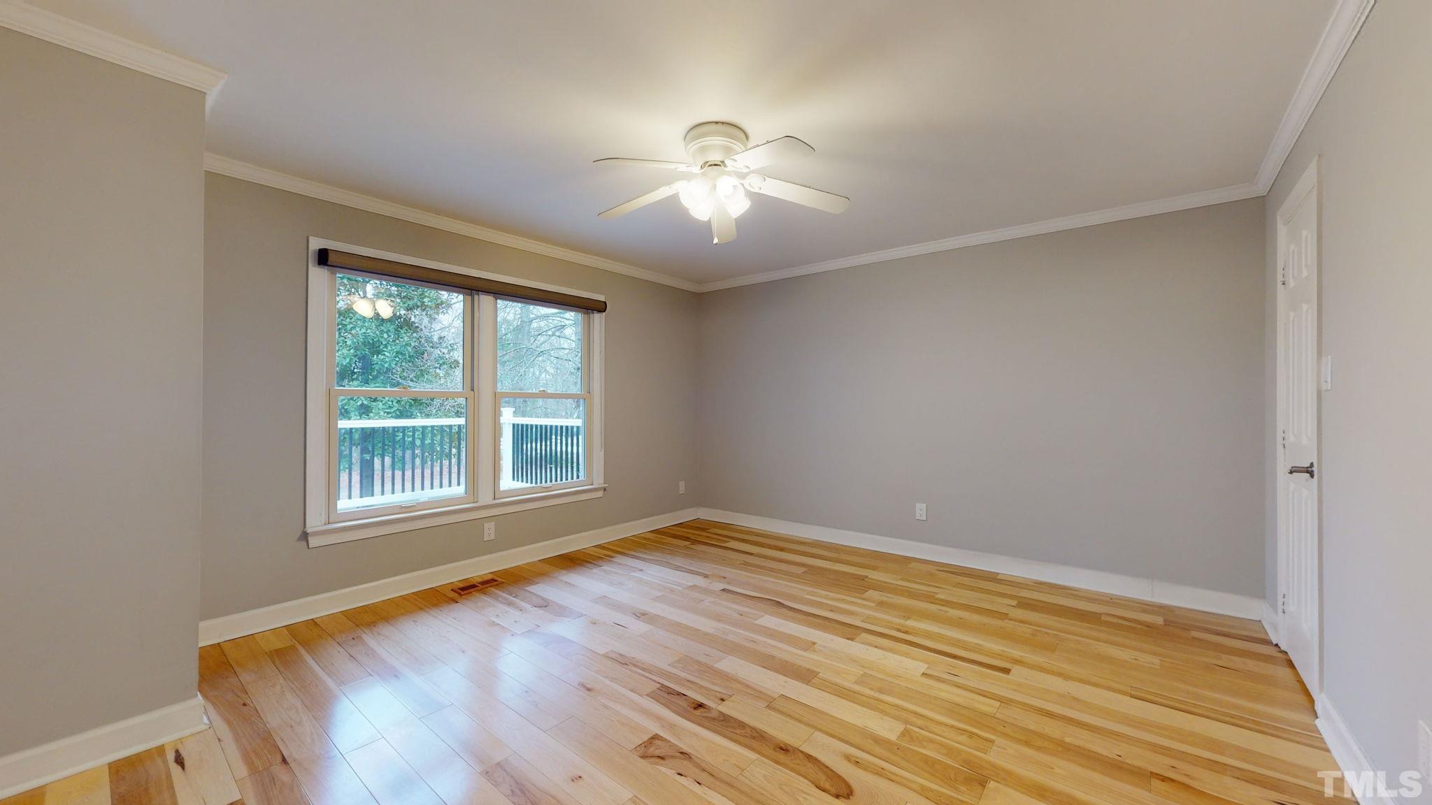 1613 Jenks Carpenter Road Cary, NC 27519 - Photo 45 of 60 a view of empty room with wooden floor and fan