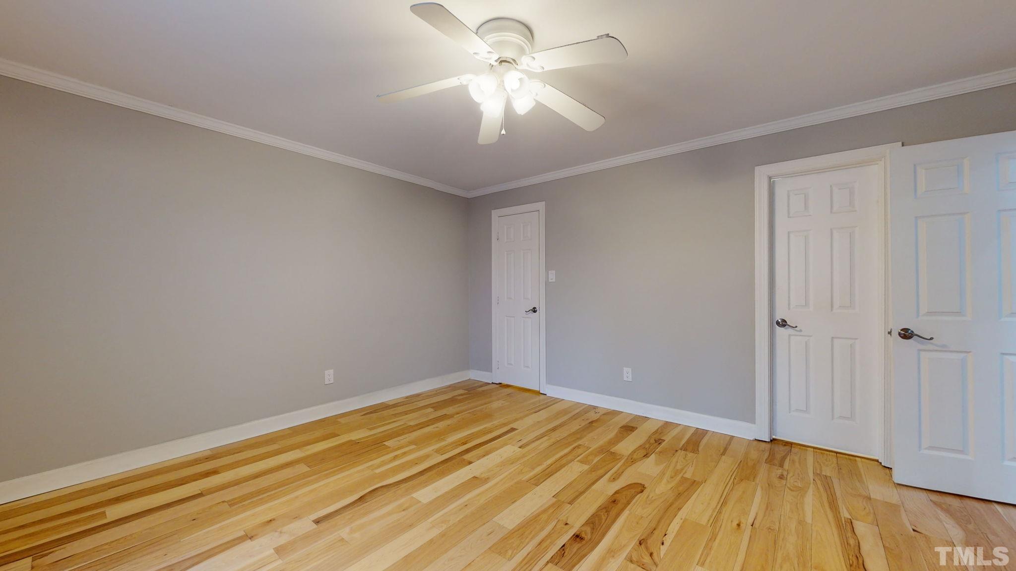 1613 Jenks Carpenter Road Cary, NC 27519 - Photo 46 of 60 a view of a room with wooden floor and a ceiling fan