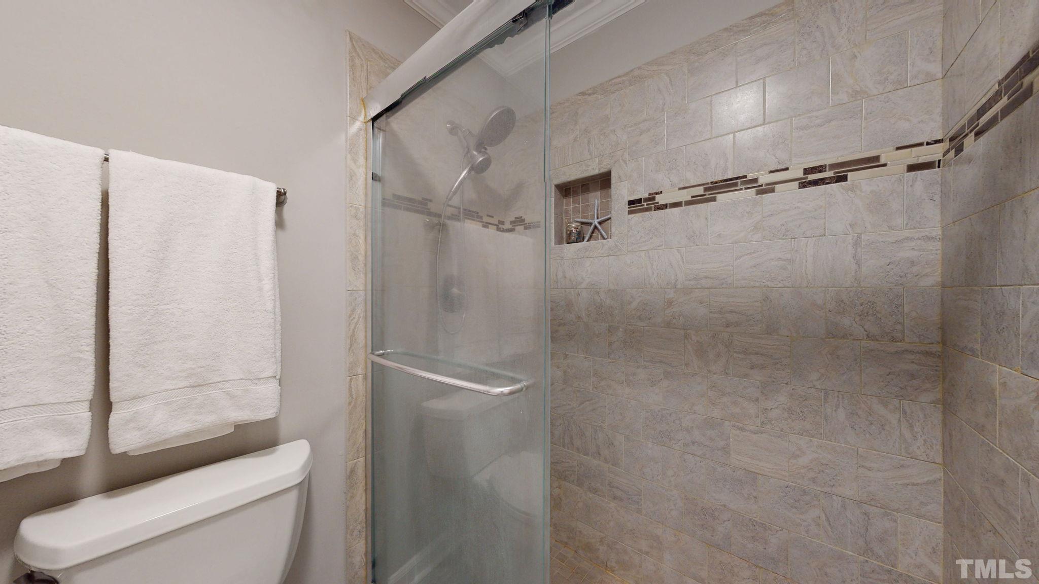 1613 Jenks Carpenter Road Cary, NC 27519 - Photo 55 of 60 a bathroom with a shower and toilet