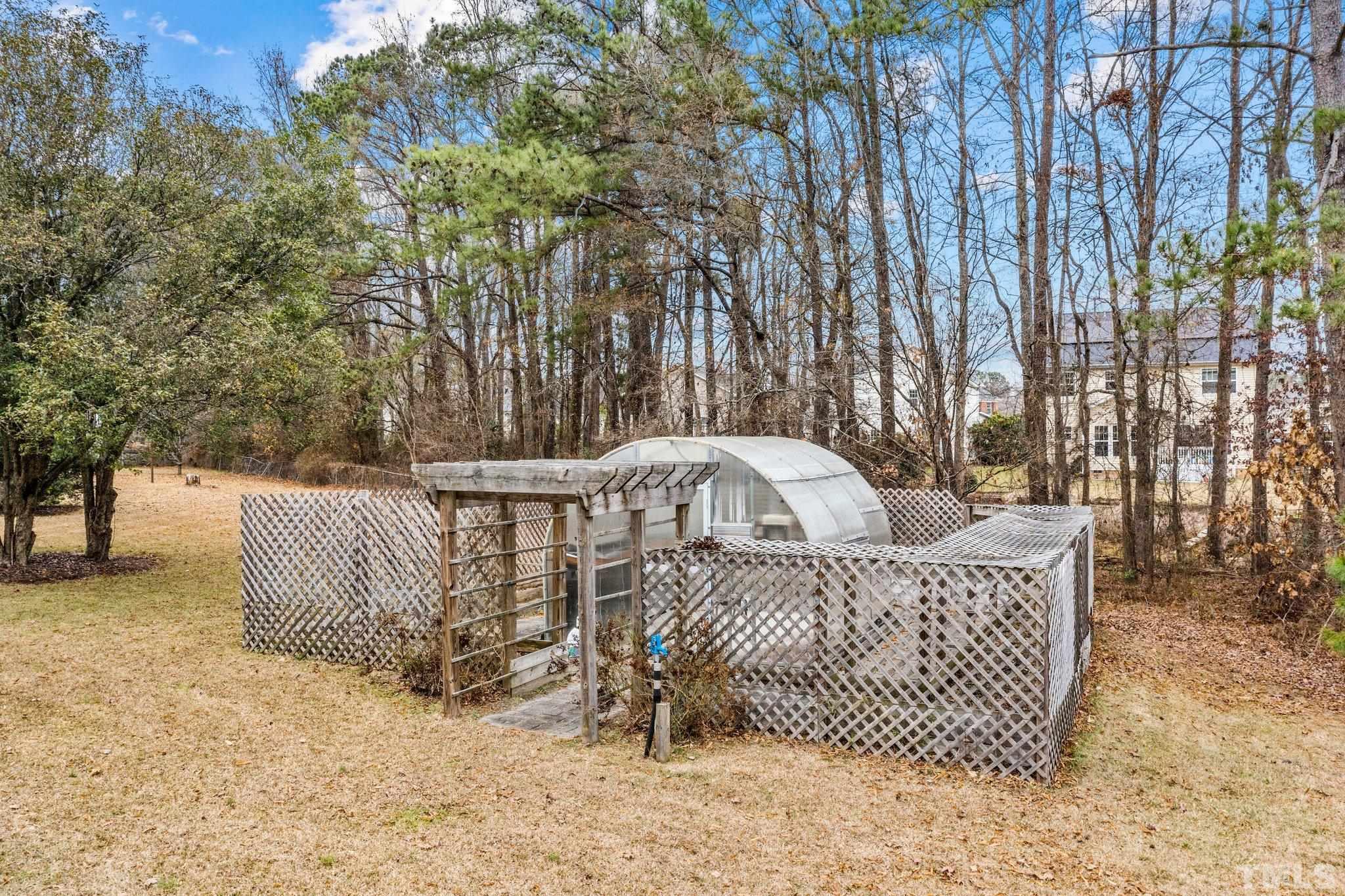 1613 Jenks Carpenter Road Cary, NC 27519 - Photo 8 of 60 a view of a patio with a couch and trees