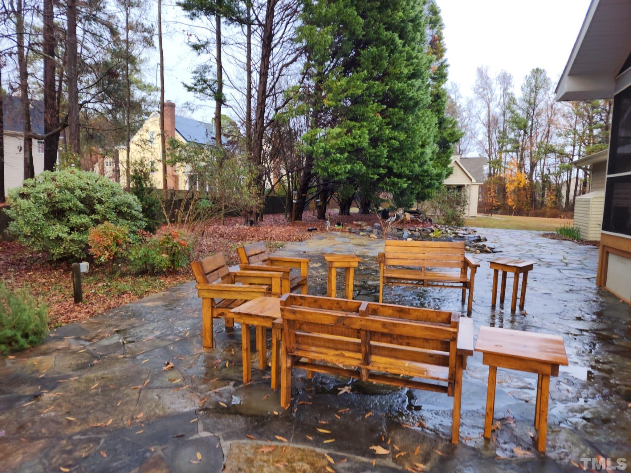 1613 Jenks Carpenter Road Cary, NC 27519 - Photo 9 of 60 a view of a patio with table and chairs with wooden fence and plants