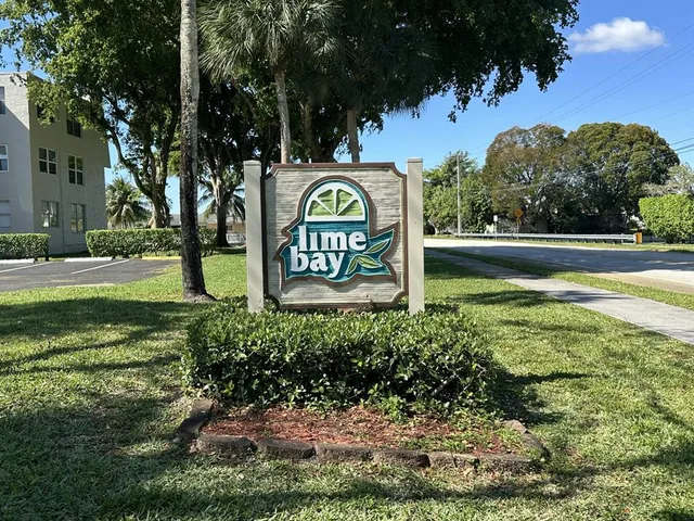 a view of a street sign under a large tree