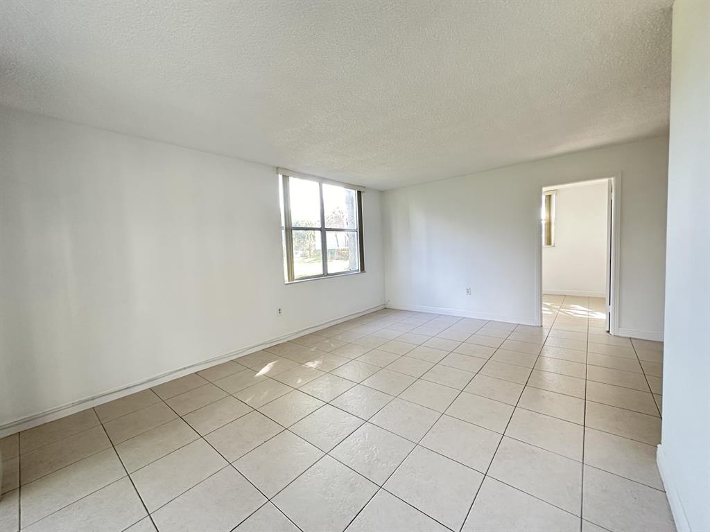 9401 Lime Bay Boulevard, Unit 115 Tamarac, FL 33321 - Photo 16 of 20 an empty room with windows