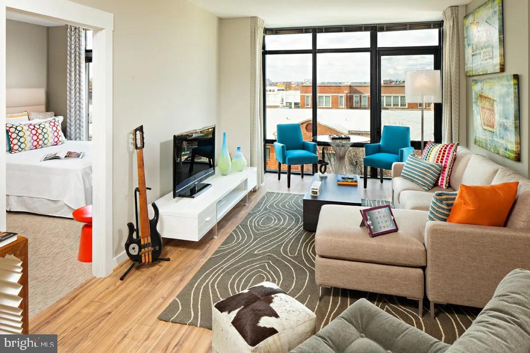 1825 Northwest 7th Street Northwest, Unit 1BR 1 Washington, DC 20001 - Photo 2 of 9 a living room with furniture and a flat screen tv