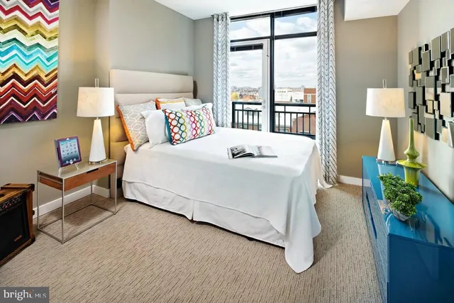 a bed sitting in a bedroom next to a window