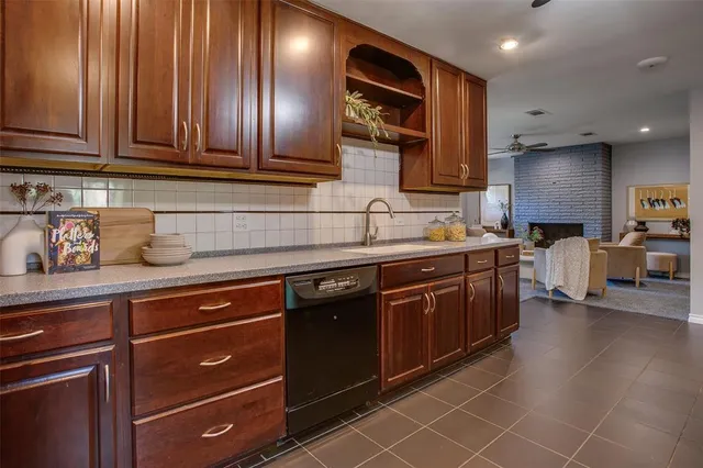 a kitchen with stainless steel appliances granite countertop a sink and cabinets