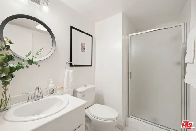 a bathroom with a toilet a sink and a mirror