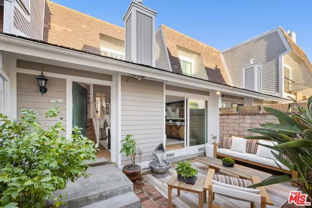 a view of a house with a chairs in a patio