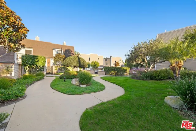 a swimming pool with outdoor seating and garden