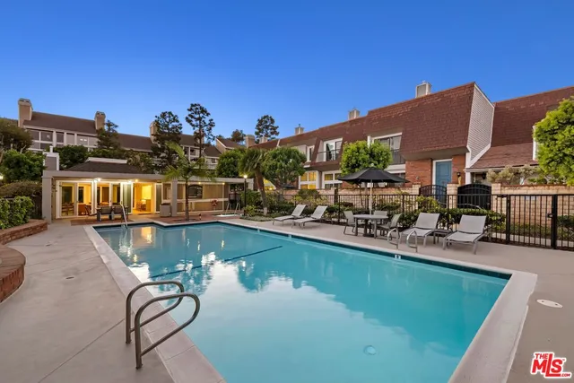 a view of a house with swimming pool yard and furniture