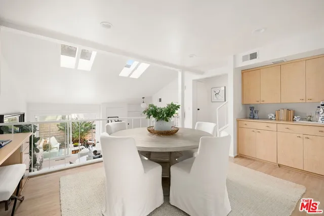 a kitchen with stainless steel appliances kitchen island granite countertop a table and chairs in it