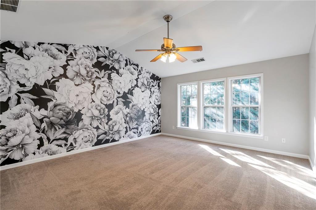 1653 Fair Oak Way Mableton, GA 30126 - Photo 13 of 30 a view of a bedroom with a window and a ceiling fan