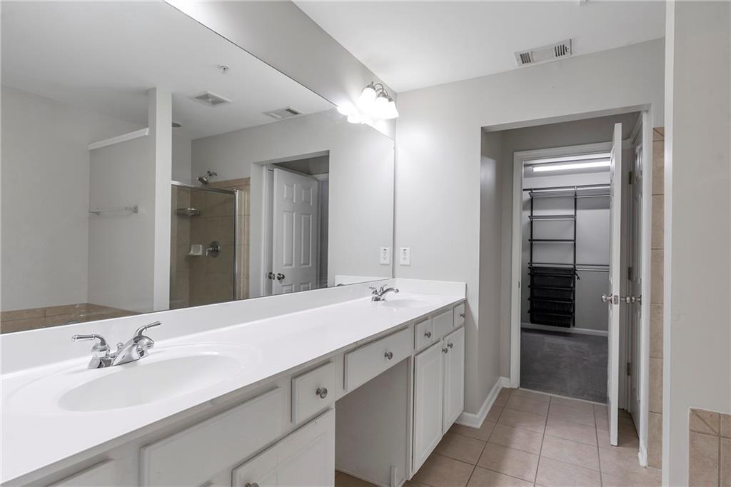 1653 Fair Oak Way Mableton, GA 30126 - Photo 16 of 30 a bathroom with a double vanity sink mirror and