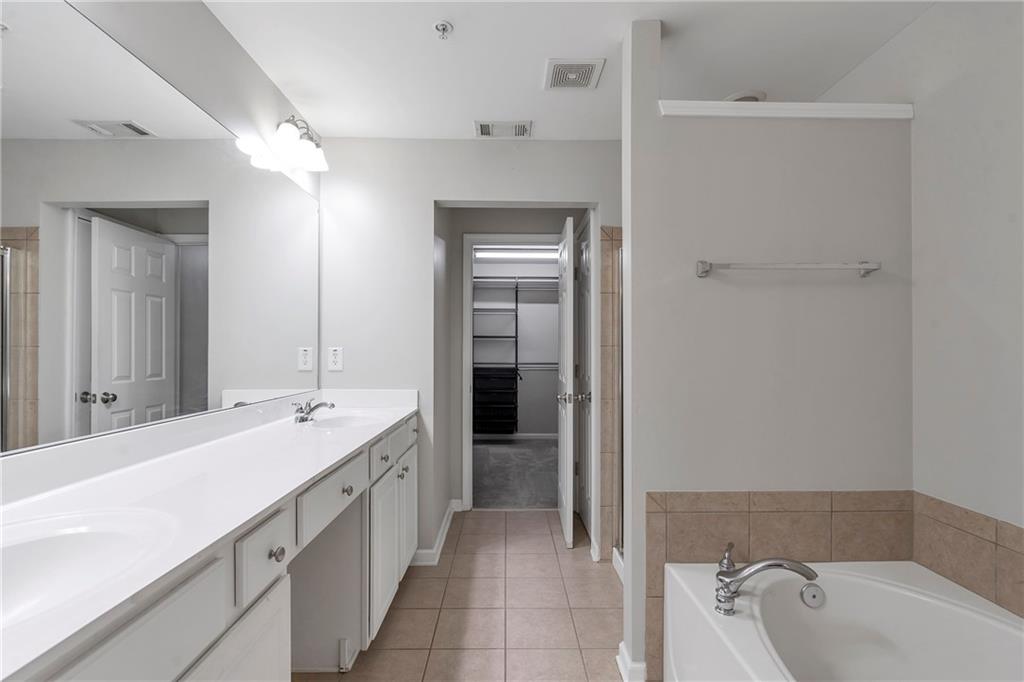 1653 Fair Oak Way Mableton, GA 30126 - Photo 18 of 30 a spacious bathroom with a tub sink and mirror
