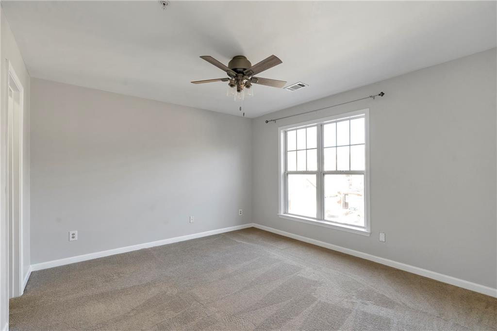 1653 Fair Oak Way Mableton, GA 30126 - Photo 20 of 30 an empty room with windows and fan