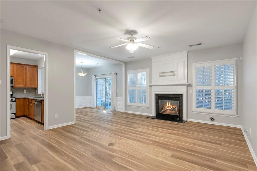 1653 Fair Oak Way Mableton, GA 30126 - Photo 3 of 30 a view of a livingroom with a fireplace a ceiling fan and wooden floor