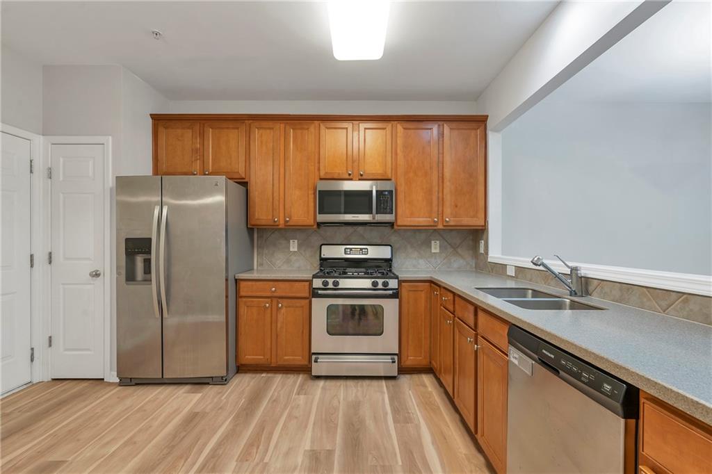 1653 Fair Oak Way Mableton, GA 30126 - Photo 7 of 30 a kitchen with a sink stove and refrigerator