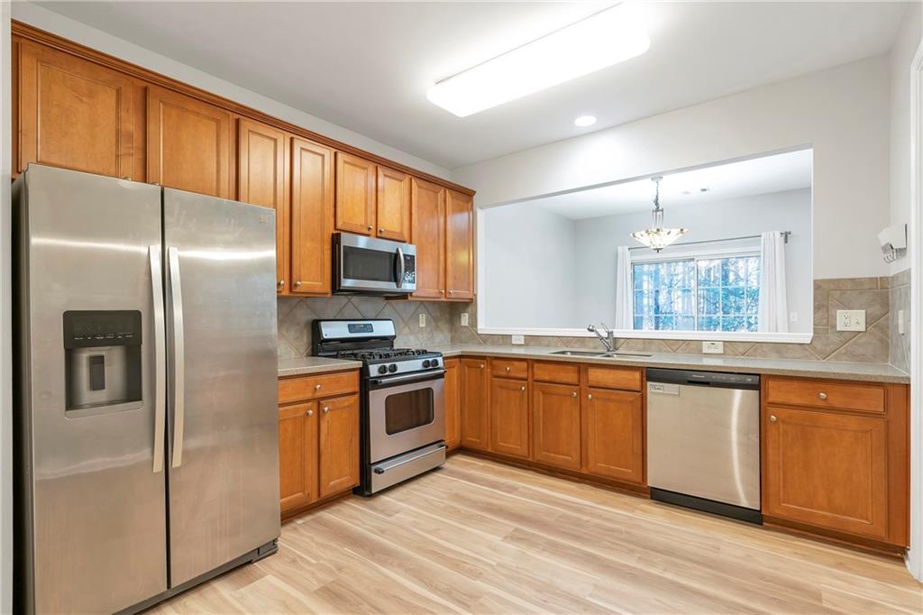 1653 Fair Oak Way Mableton, GA 30126 - Photo 9 of 30 a kitchen with stainless steel appliances granite countertop a refrigerator stove top oven and sink