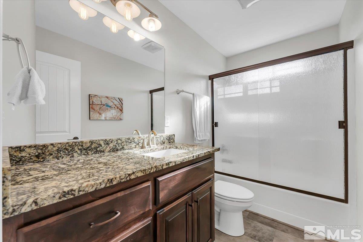 3071 Schindler Road Fallon, NV 89406 - Photo 16 of 40 a bathroom with a granite countertop sink toilet and shower