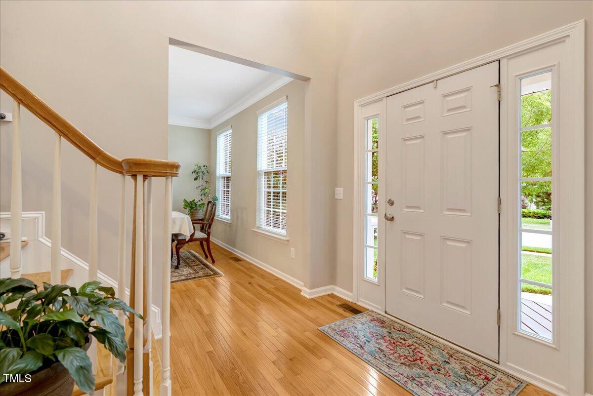 201 Forbes Road Wake Forest, NC 27587 - Photo 12 of 42 a view of an entryway with wooden floor and a livingroom