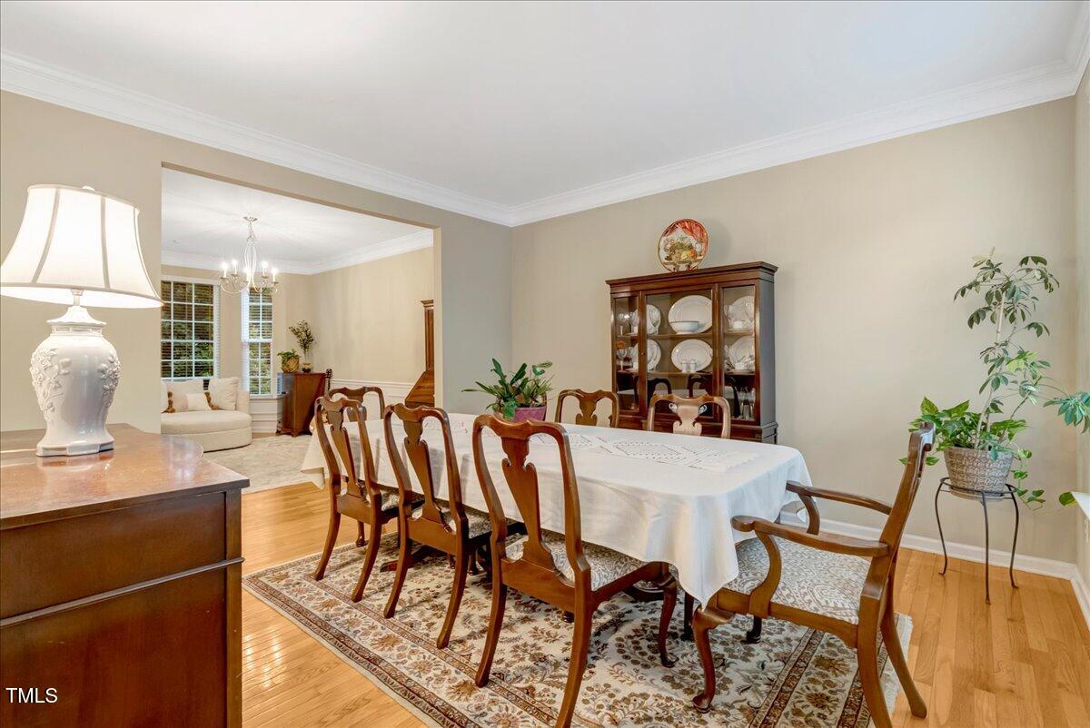 201 Forbes Road Wake Forest, NC 27587 - Photo 14 of 42 a view of a dining room with furniture and wooden floor