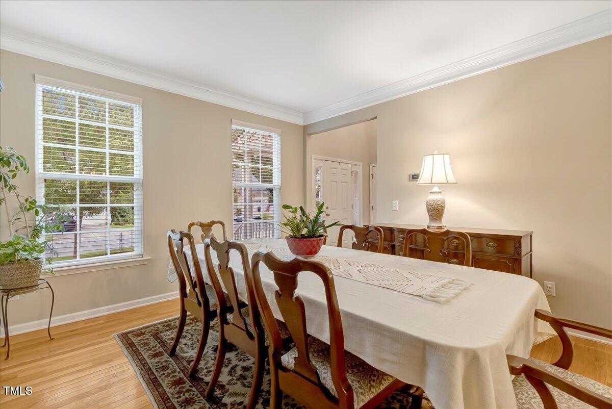 201 Forbes Road Wake Forest, NC 27587 - Photo 15 of 42 a view of a dining room with furniture and wooden floor