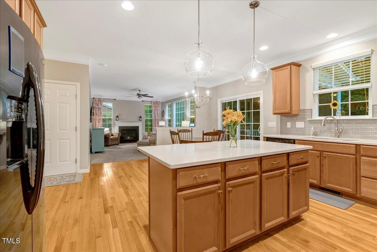 201 Forbes Road Wake Forest, NC 27587 - Photo 23 of 42 a large kitchen with kitchen island a large counter top space a sink stainless steel appliances and cabinets