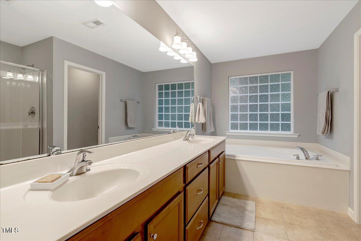 201 Forbes Road Wake Forest, NC 27587 - Photo 33 of 42 a bathroom with a bathtub sink and mirror