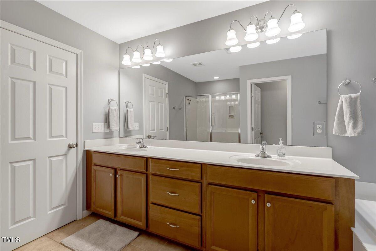 201 Forbes Road Wake Forest, NC 27587 - Photo 34 of 42 a bathroom with double vanity sinks and a mirror