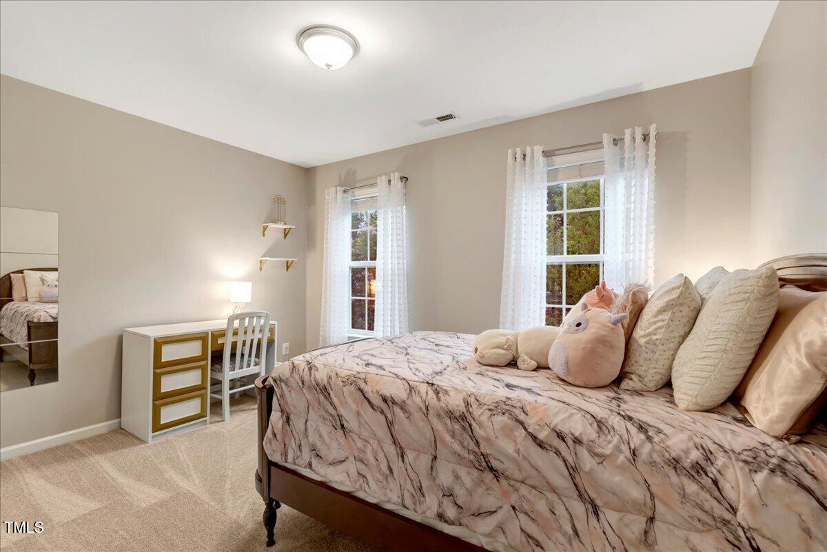 201 Forbes Road Wake Forest, NC 27587 - Photo 35 of 42 a bedroom with a large bed and a window
