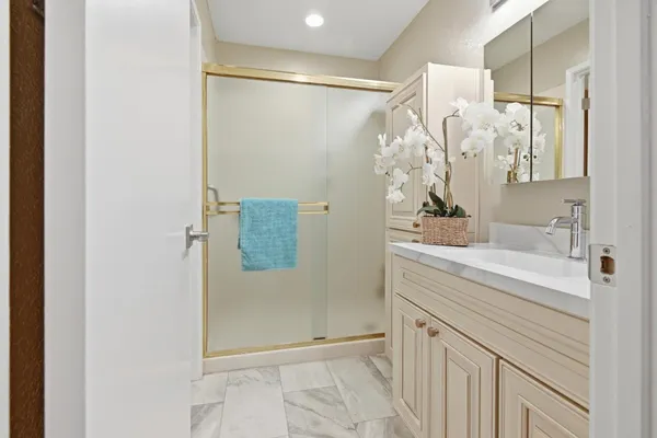 a bathroom with a shower and a sink