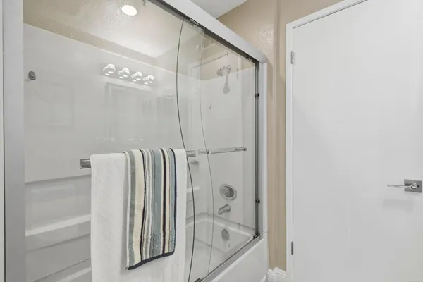 a bathroom with a bathtub and a shower