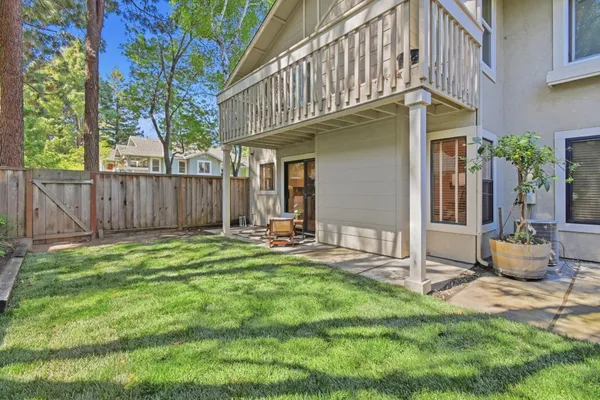 a backyard of a house with table and chairs