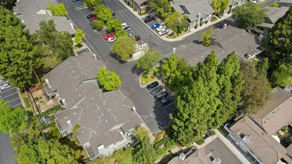 an aerial view of residential houses with outdoor space