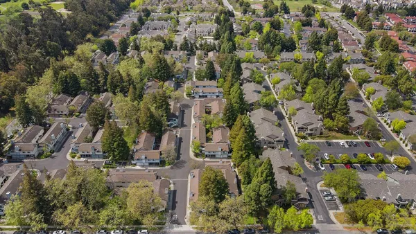 an aerial view of residential houses with outdoor space