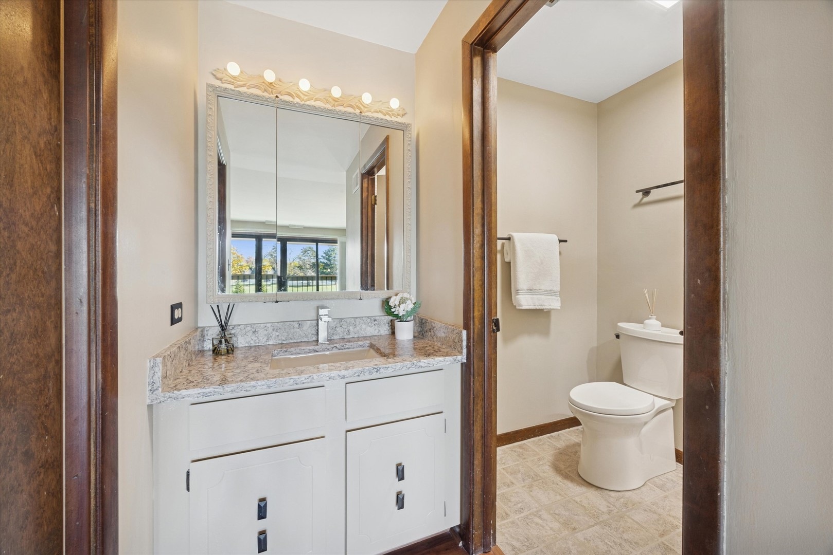 7990 Garfield Avenue, Unit 143 Burr Ridge, IL 60527 - Photo 14 of 16 a bathroom with a toilet sink and mirror