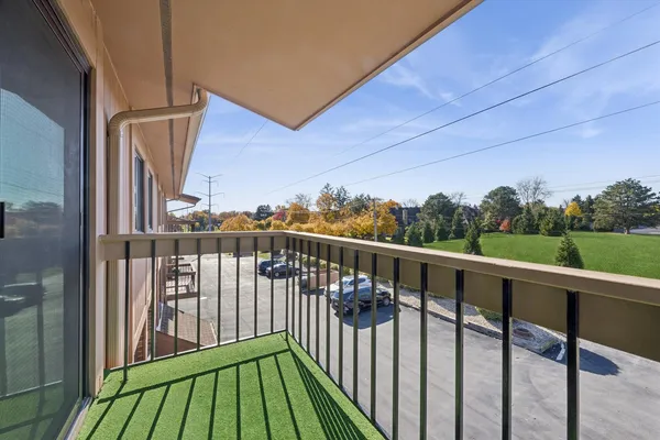 a view of balcony with wooden floor and fence
