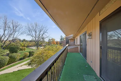 a view of a pathway of a yard from a balcony