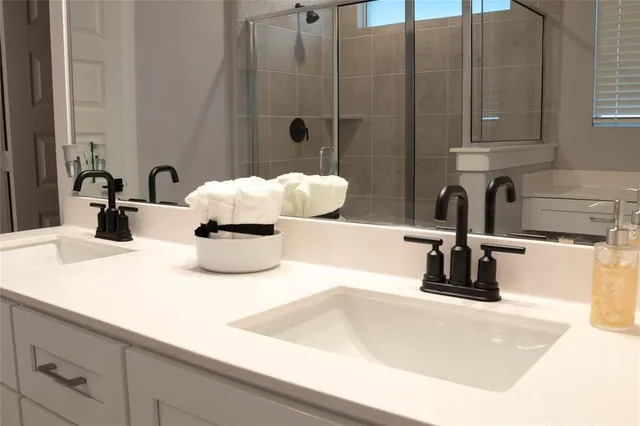 a bathroom with a double vanity sink