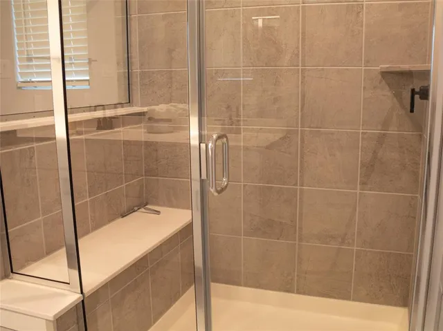 a bath tub sitting next to a shower